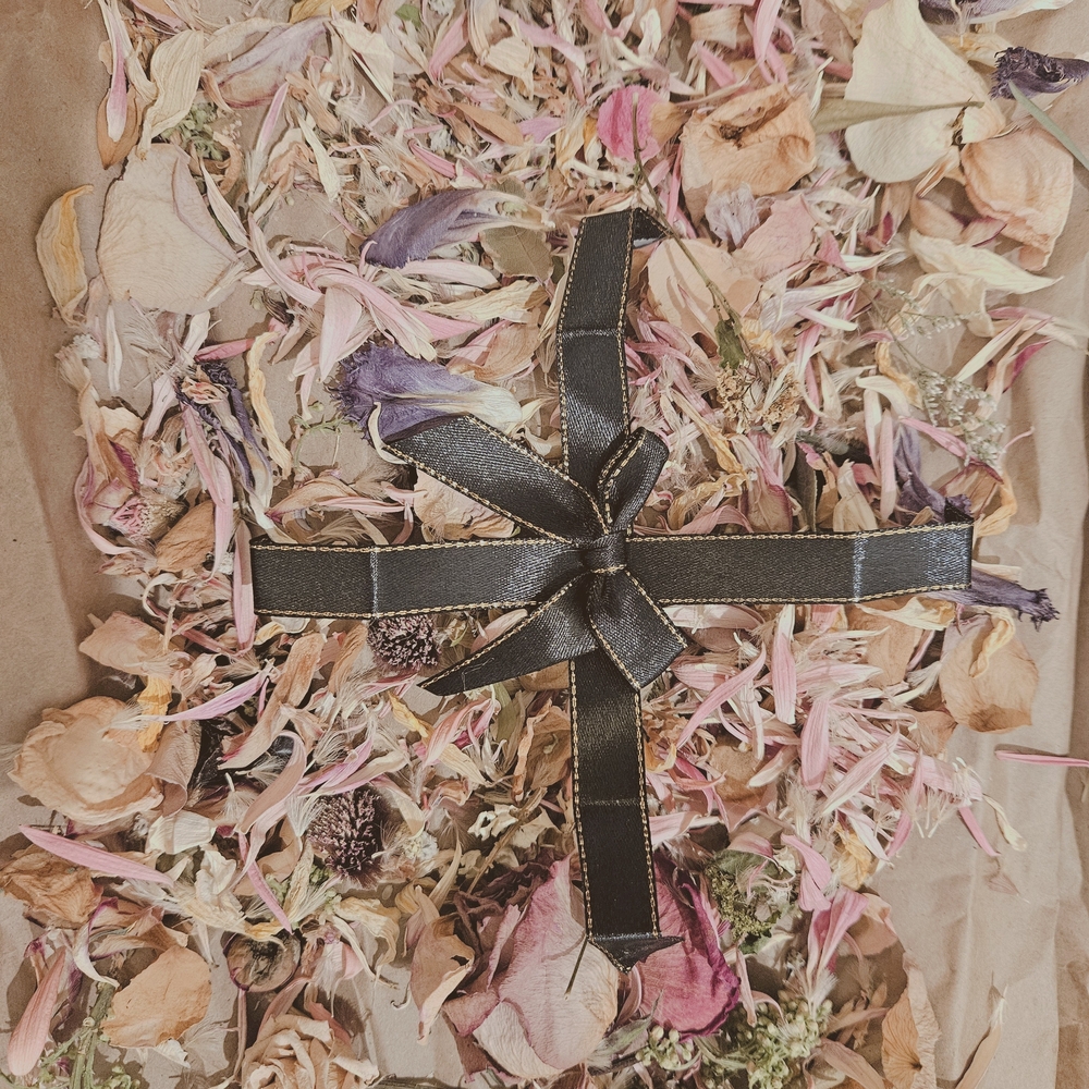 Hand-dried Black Ribbon on Floral Petal Arrangement
